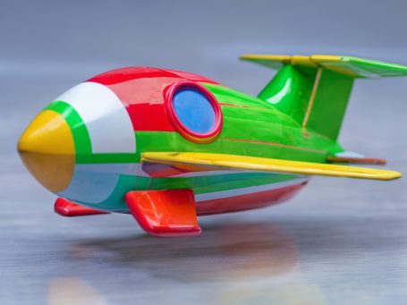 Colorful toy airplane with red, green, blue, and yellow accents.